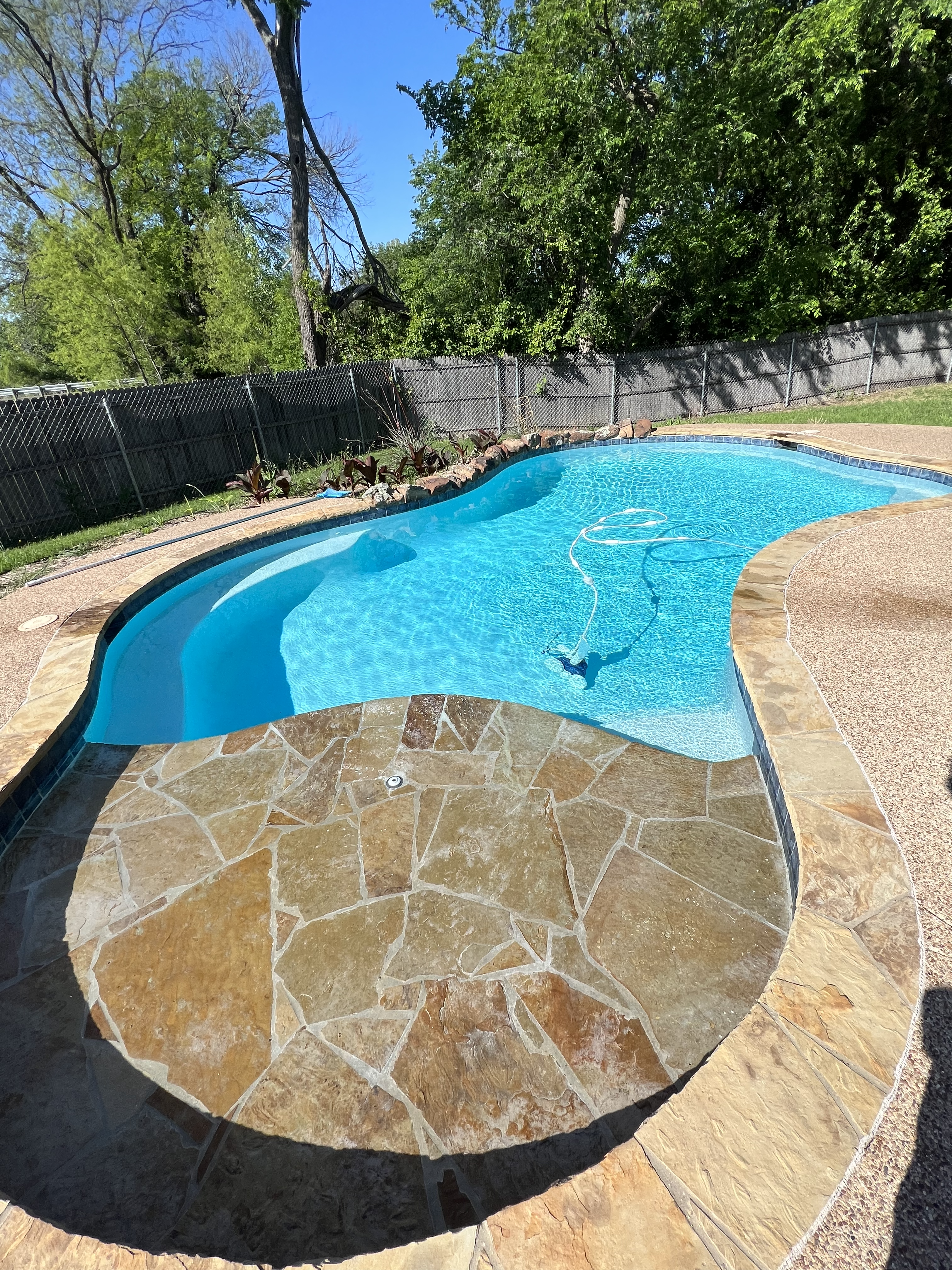 Clean pool water surface in Helotes TX