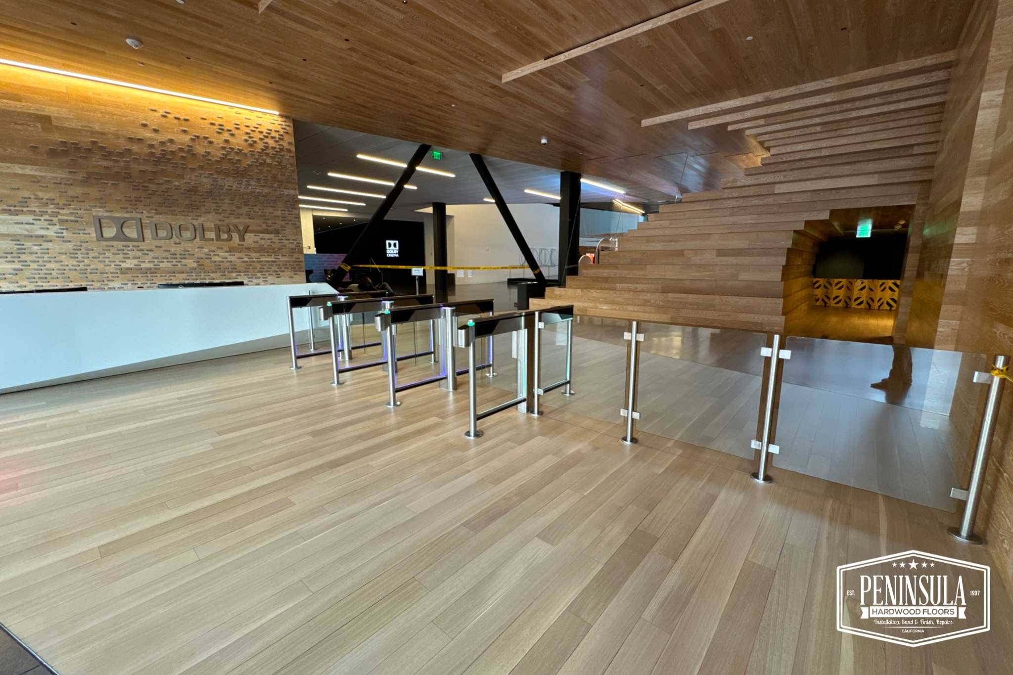 Commercial space hardwood floor installation and staircase