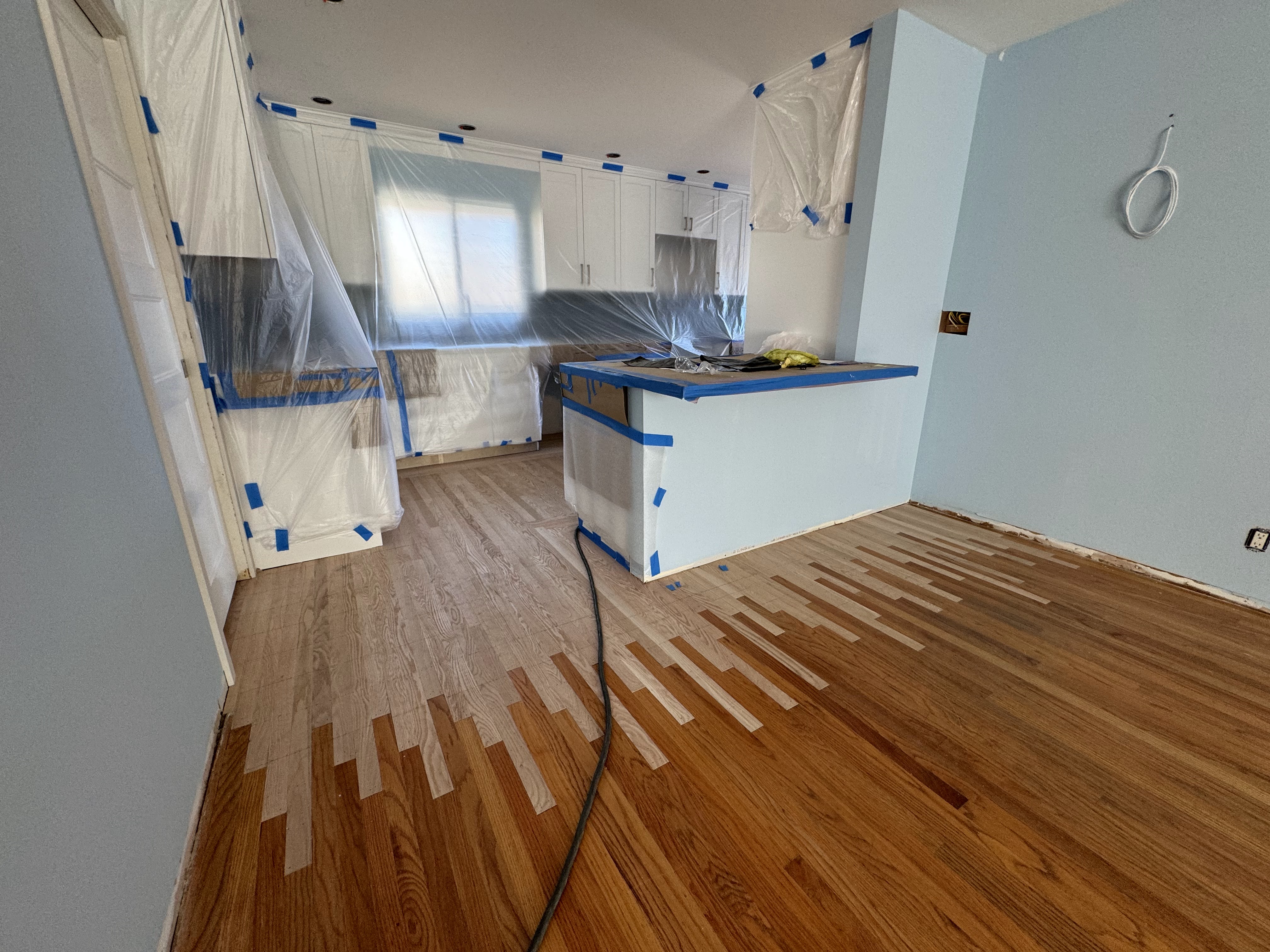 Subfloor preparation and hardwood installation in kitchen