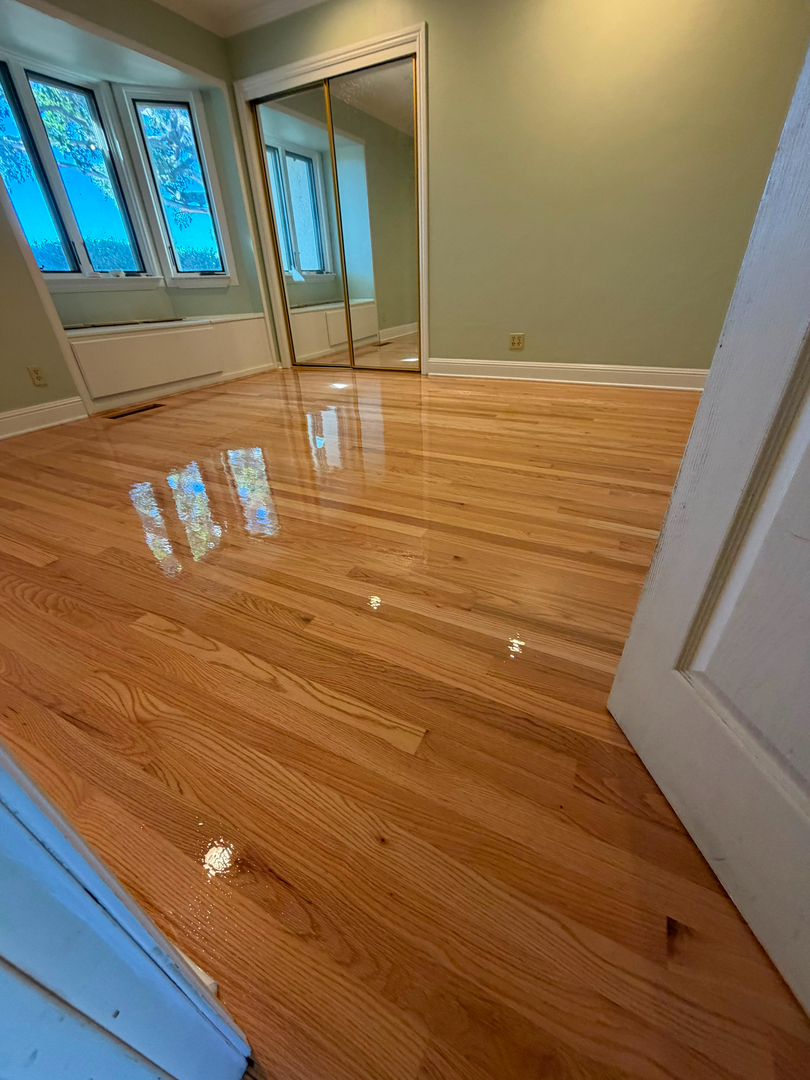Refinished glossy hardwood floor in living room