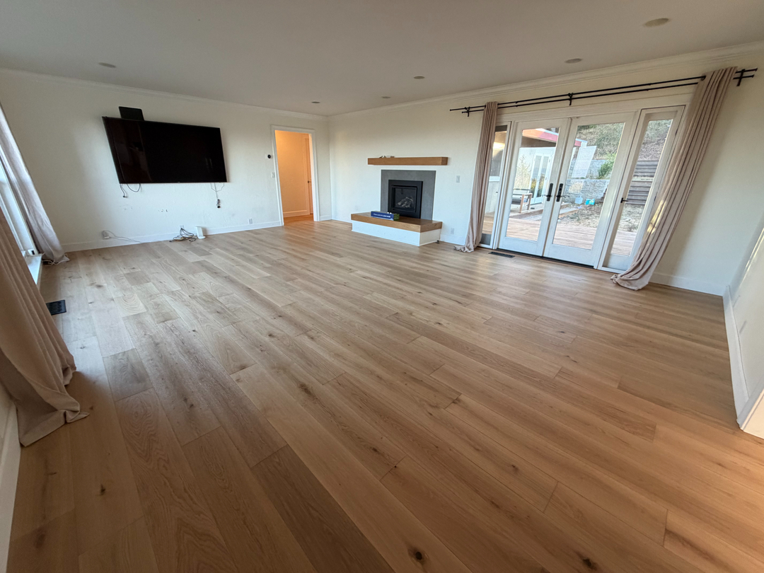Living room with natural lighting and refinished wood floors